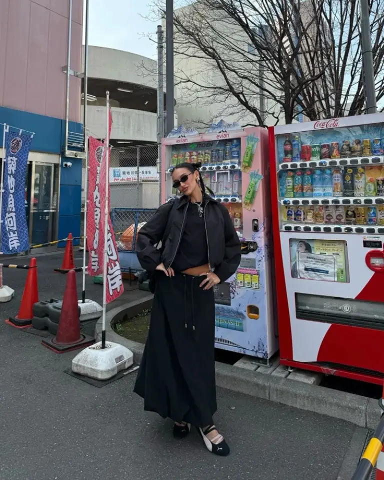 woman in brown leather jacket black midi dress brown loafers baseball cap traditional historic street outfit 11