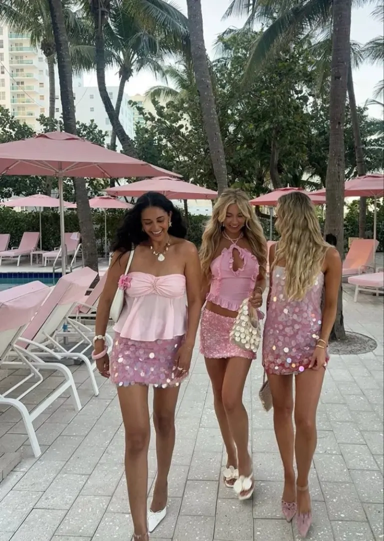 three women in desert setting wearing sequin mini skirts crop tops white and pattern during sunset outfit 16