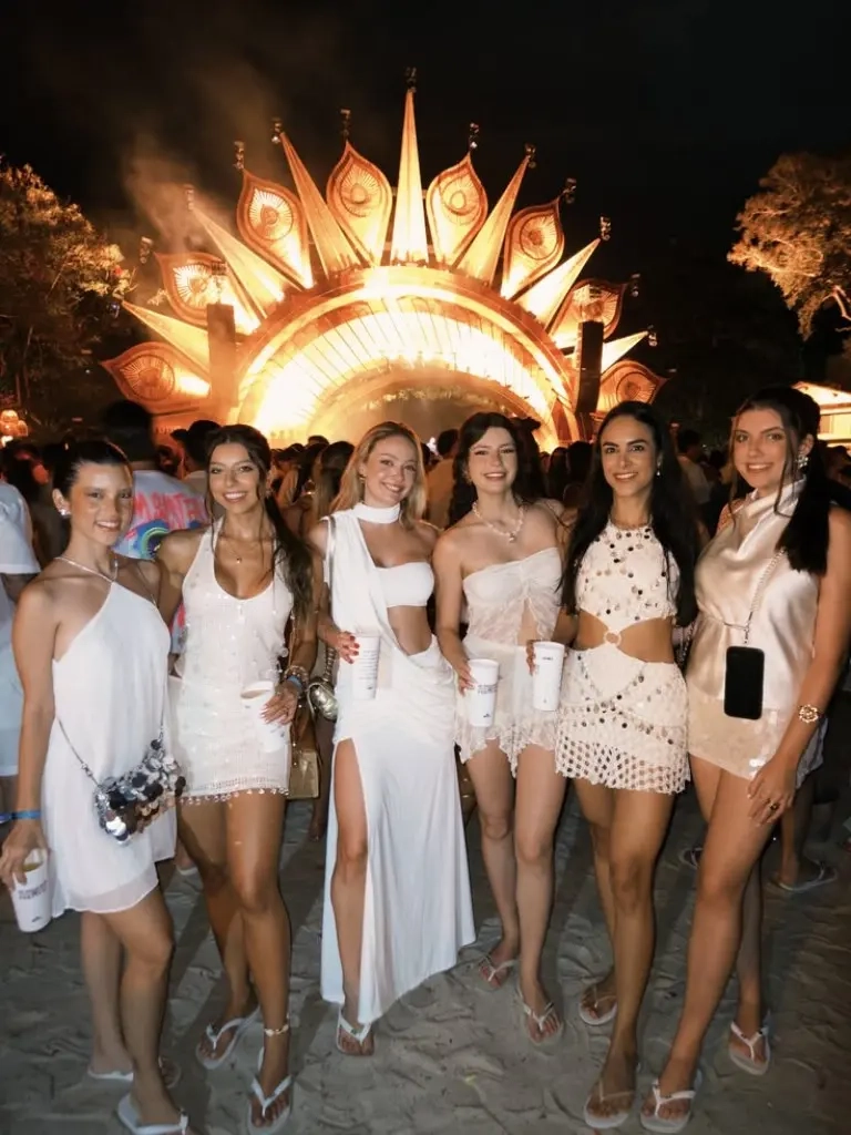 group of women in white outfits at outdoor festival setting various white dresses and separates outfit 10