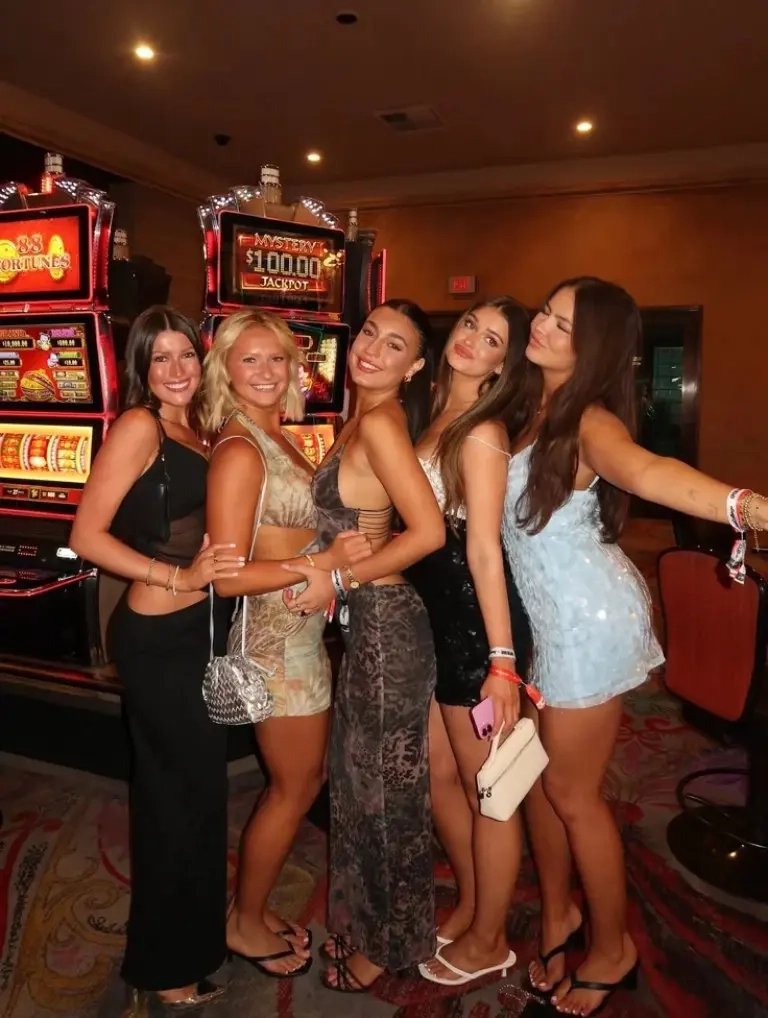 group of women in mixed casino outfits bodycon dresses snake print maxi sequin details outfit 2