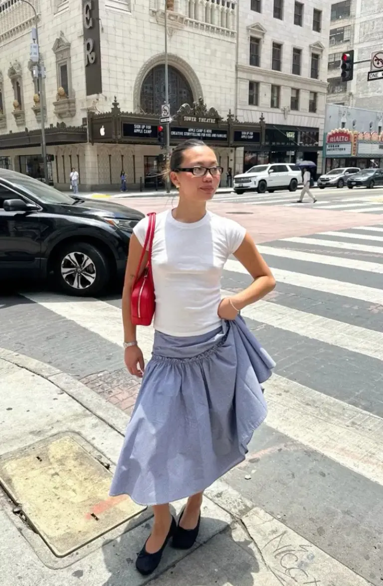 white cotton t-shirt blue chambray tiered skirt black loafers red crossbody bag urban street outfit 4
