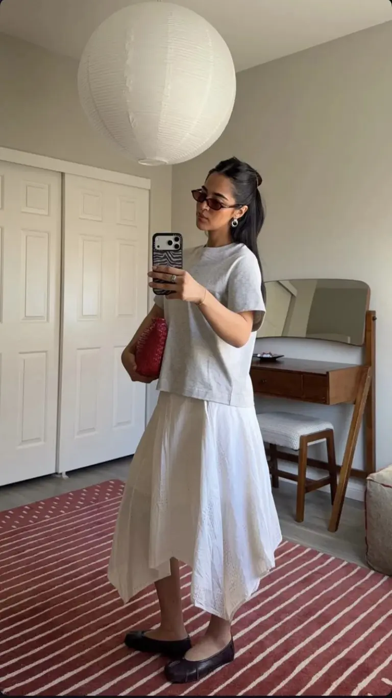 gray oversized t-shirt white pleated midi skirt black ballet flats red leather clutch museum outfit 5