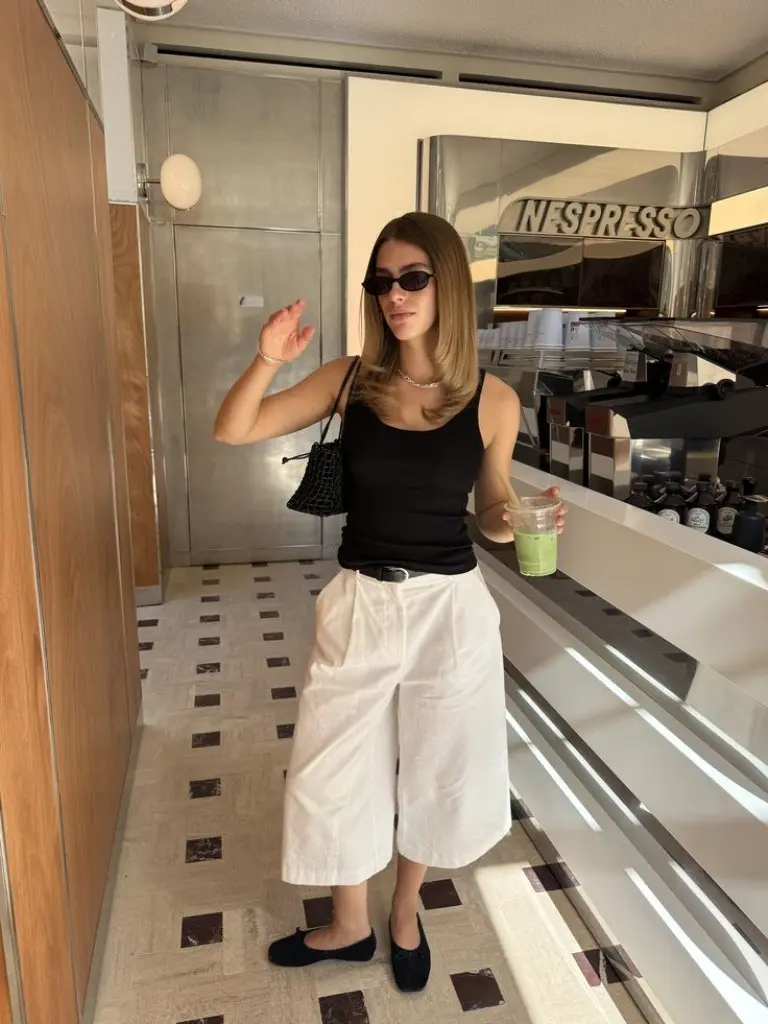 black ribbed tank top beige wide leg cropped trousers black loafers structured handbag sunglasses outfit 7