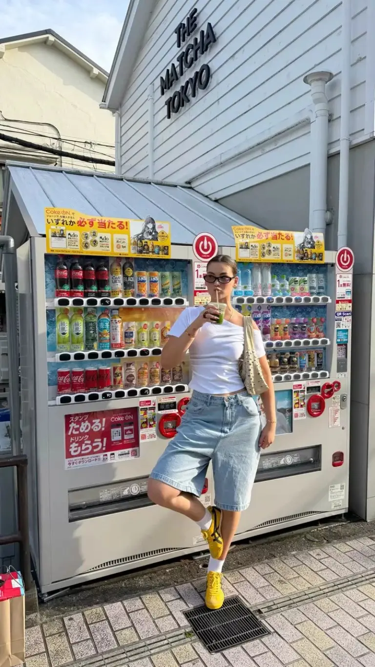 white cotton t-shirt denim bermuda shorts yellow sneakers canvas crossbody bag train station outfit 10