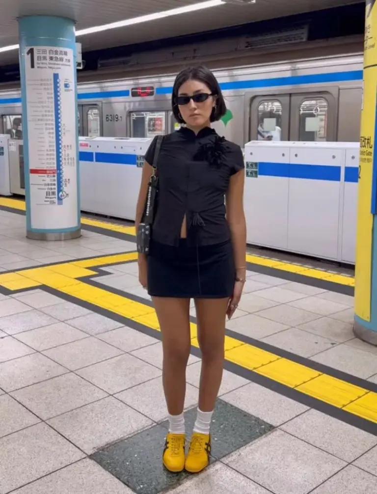 black cap sleeve top gray fitted mini skirt yellow sneakers black crossbody bag underground shopping outfit 18