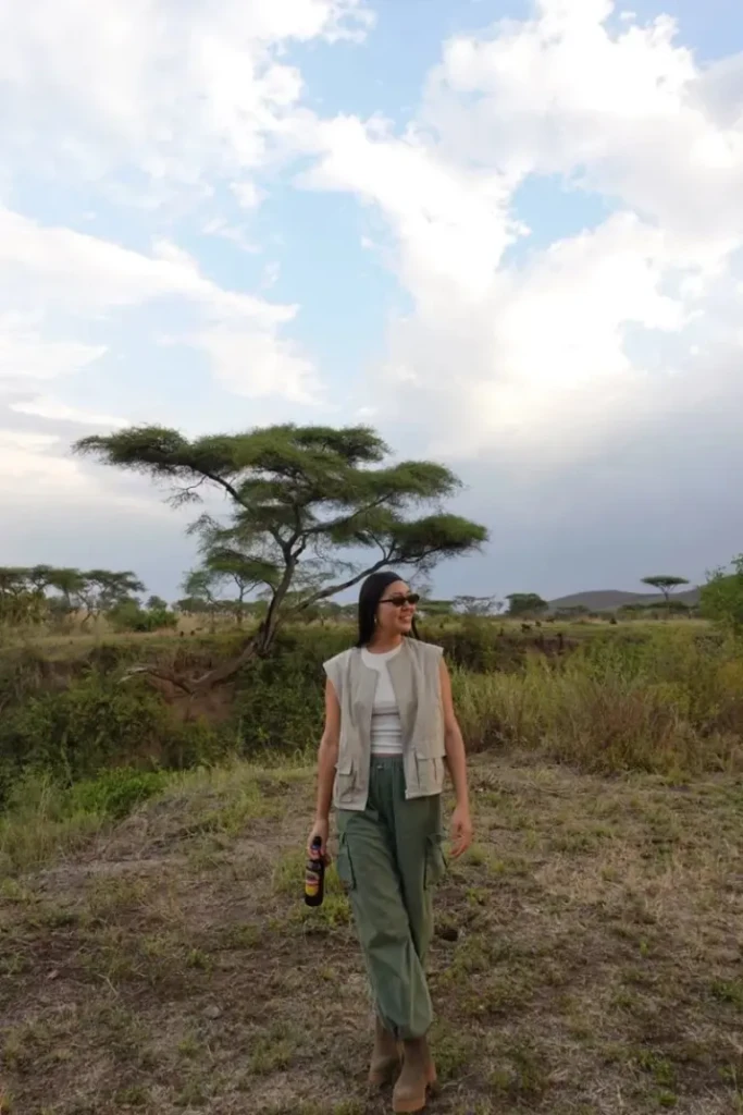 khaki utility vest white tank top wide leg green pants acacia trees savanna outfit 7