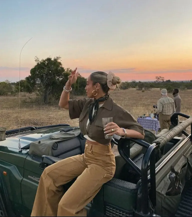 olive safari shirt khaki pants wide brim hat binoculars sunset savanna vehicle outfit 10