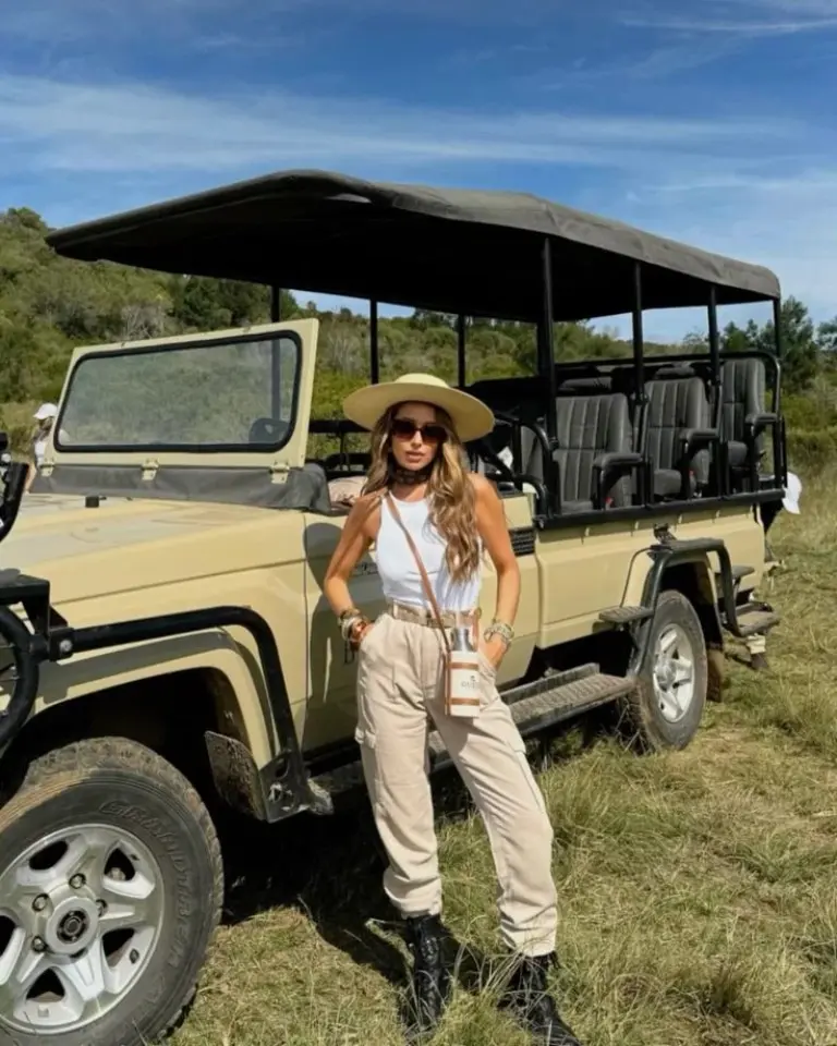 beige fringe jacket olive cargo pants safari hat black boots vehicle trees outfit 17