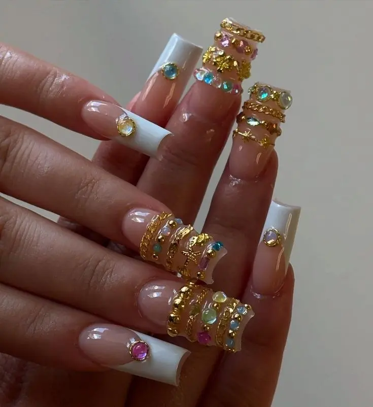 long square white French tip nails with gold chain wraps multicolor gems and opal cabochons on accent nails photo 1