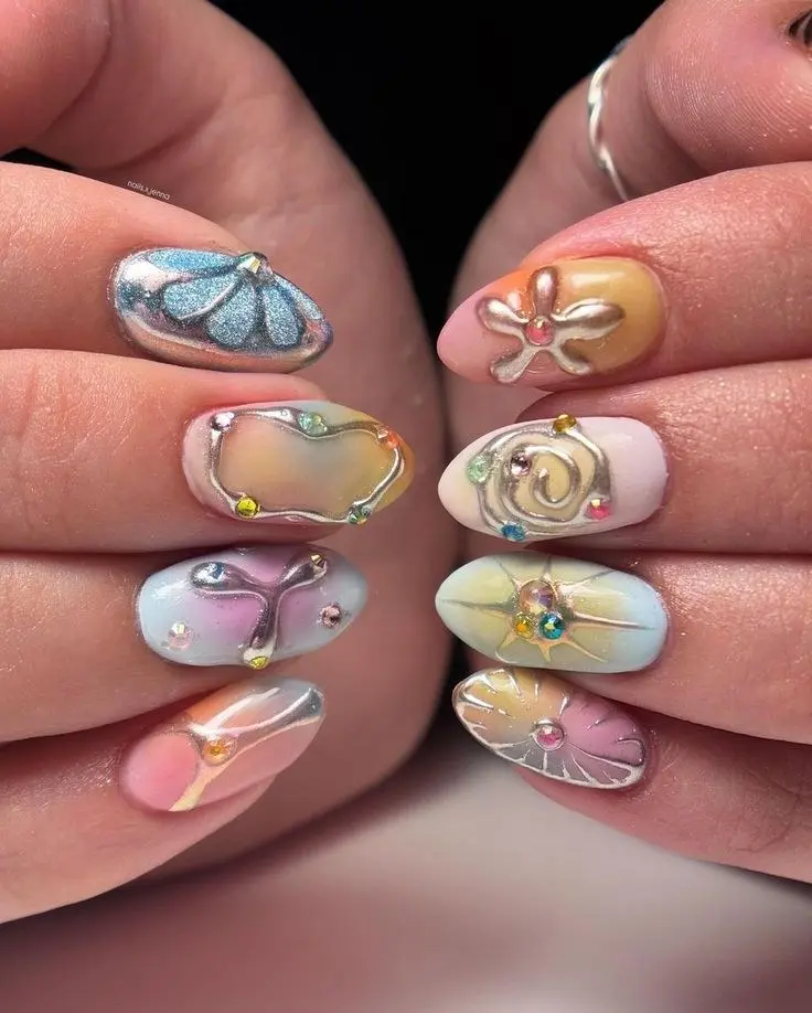 medium almond nails with pastel watercolor base in blue peach lilac mint with silver chrome butterfly bow sun and spiral motifs and gem centers photo 7