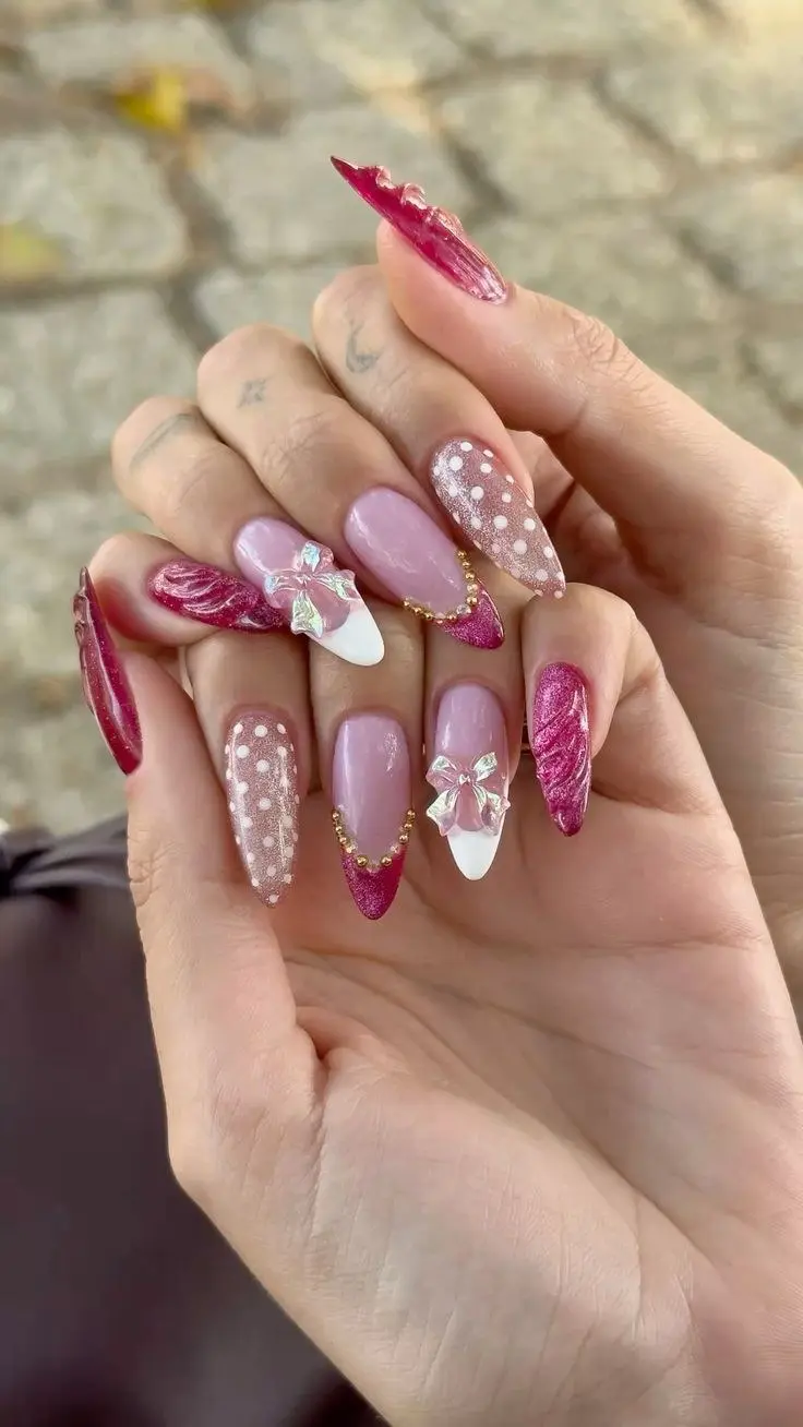 medium almond nails in mixed berry marble polka dot and white French base with large 3D iridescent bow charm and gold bead chain photo 8