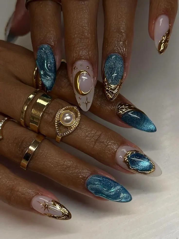 medium almond teal metallic chrome marble nails with nude accent nails featuring gold crescent moon starburst and constellation nail charms photo 11