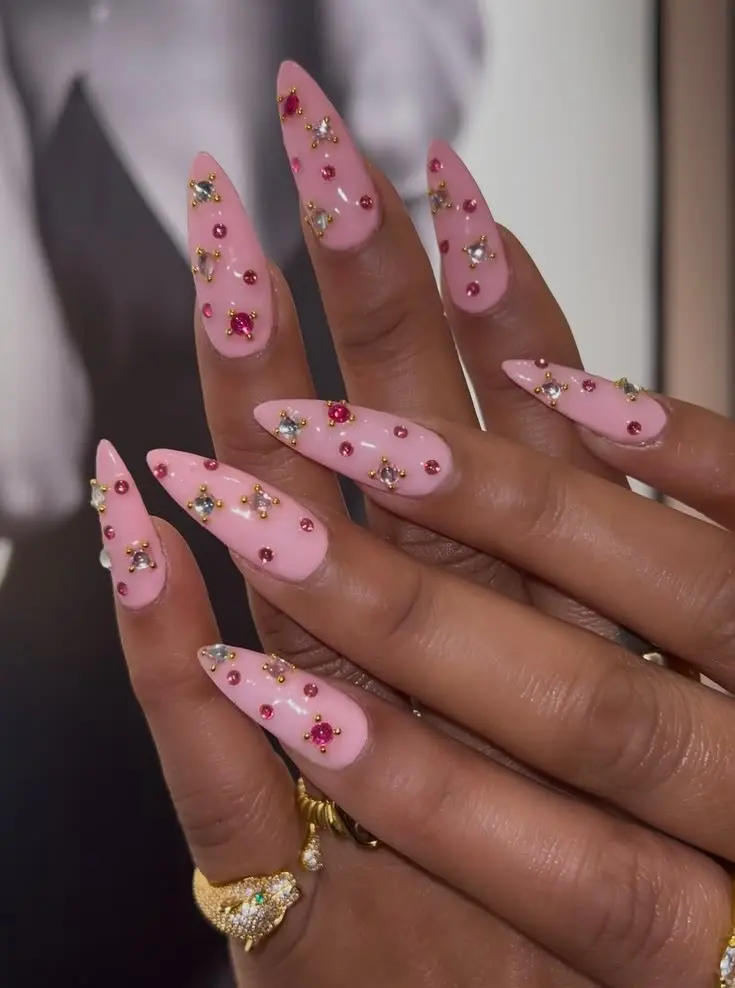 medium long stiletto baby pink glossy nails with scattered mixed pink cabochon and clear star rhinestone gems with gold prong settings photo 12