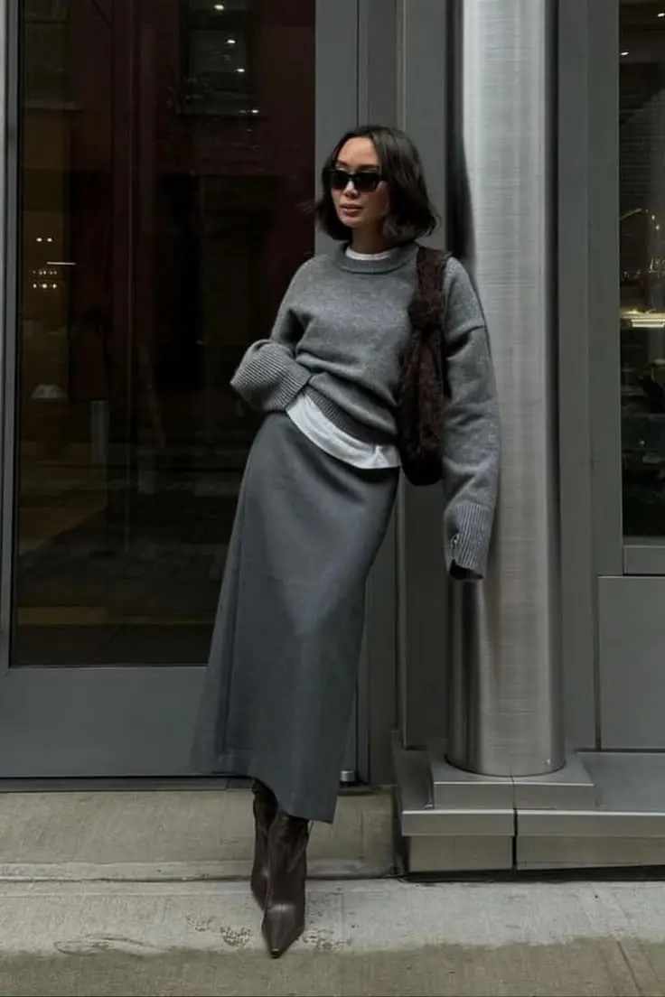 woman in matching grey oversized knit sweater grey midi skirt white tee hem visible dark brown pointed boots dark fur bag sunglasses fall work outfit 4