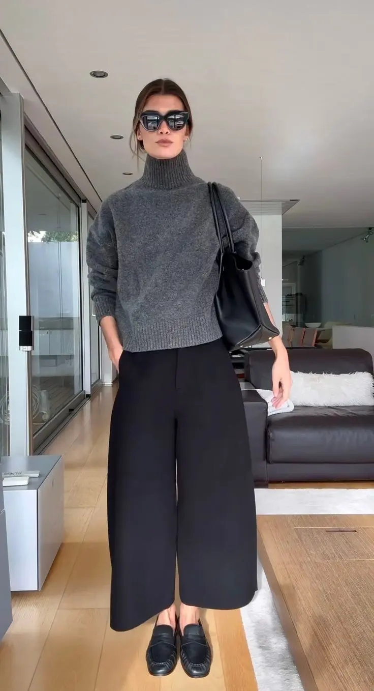 woman in grey cropped turtleneck sweater black wide leg tailored trousers black leather loafers large black leather tote bag oversized sunglasses fall work outfit 7