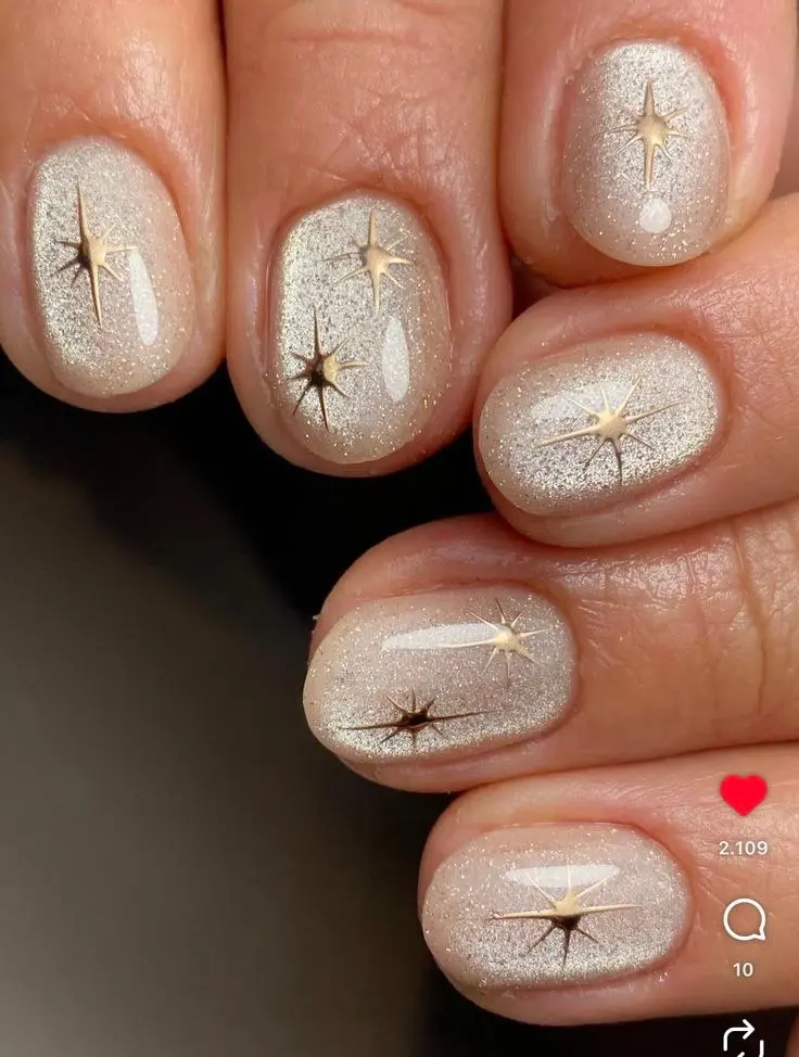 short round nails champagne beige micro glitter gel base with gold starburst nail art on each nail photo 5