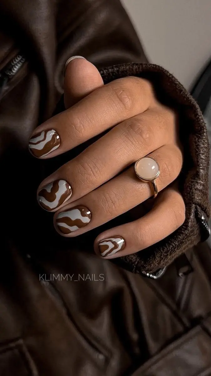 short rounded square nails alternating chocolate brown and white base with wavy abstract line nail art in contrasting color photo 7