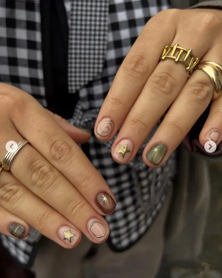 short square nails mixed earth tone gel nude olive dark brown with individual gold swirl star and starburst details on each nail photo 10