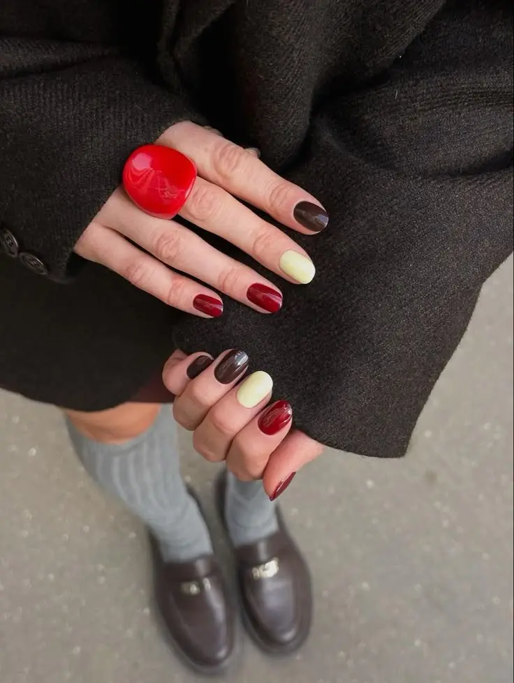 short round nails multi-color block manicure deep oxblood dark brown cranberry and chartreuse yellow each nail different color photo 12