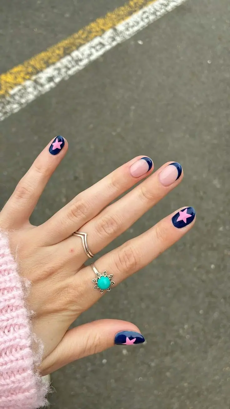 short round and oval nails deep navy blue gel with large pink star nail art one nude accent nail with navy color-block French cuticle detail photo 18