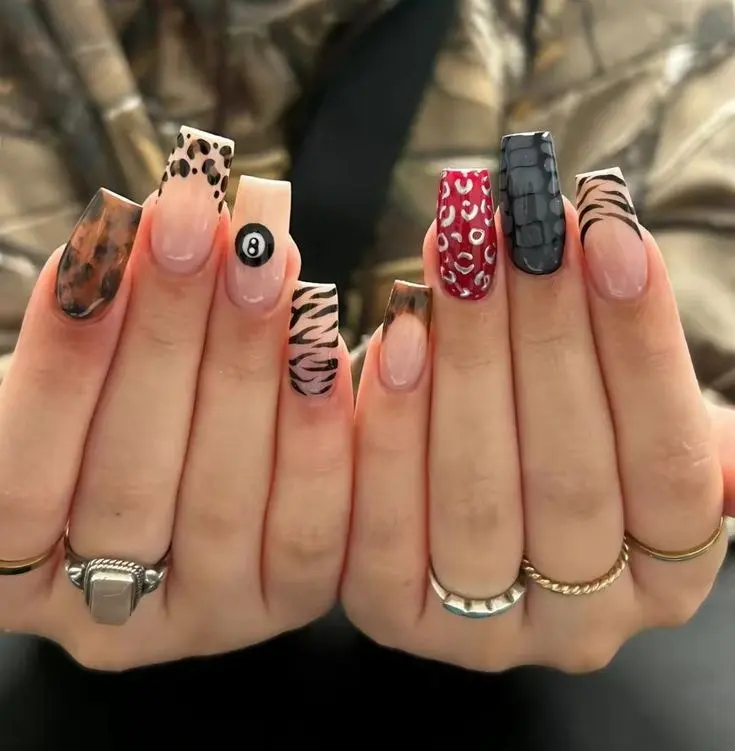 long square nails with mixed animal print designs including leopard, zebra, croc, red cheetah, and 8-ball accent nail, both hands shown, photo 3