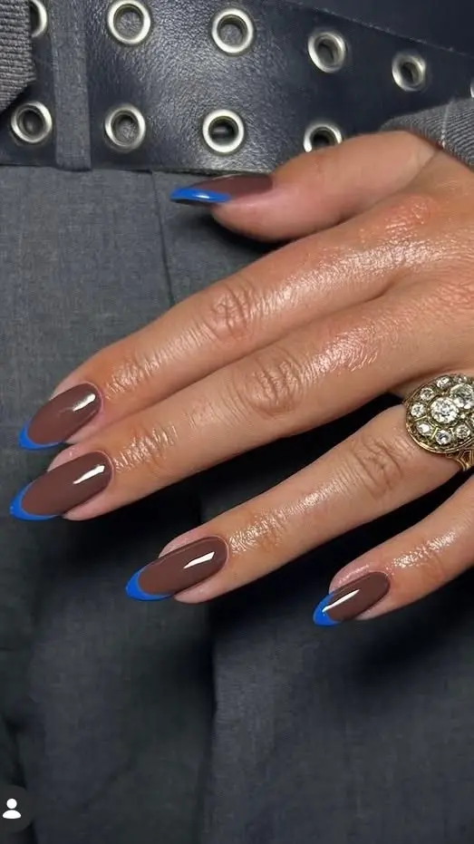 long almond nails in warm mocha brown with electric cobalt blue French tips, worn with a rhinestone cocktail ring, photo 5