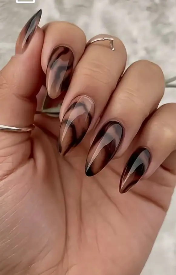 very long stiletto-adjacent almond nails with tortoiseshell swirl design in amber caramel brown and black, high gloss finish, silver ring, photo 10