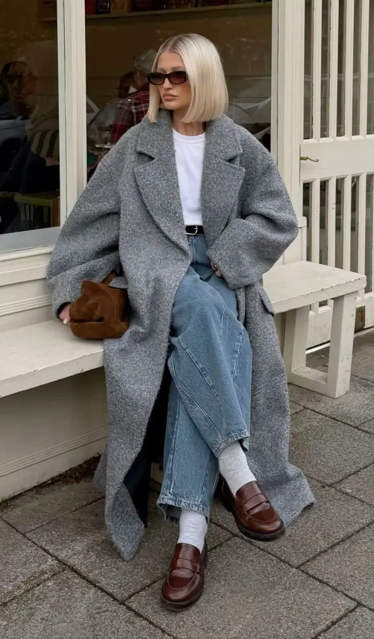 Oversized camel cocoon coat over ribbed turtleneck and straight-leg black trousers, chunky ankle boots, city sidewalk fall street style