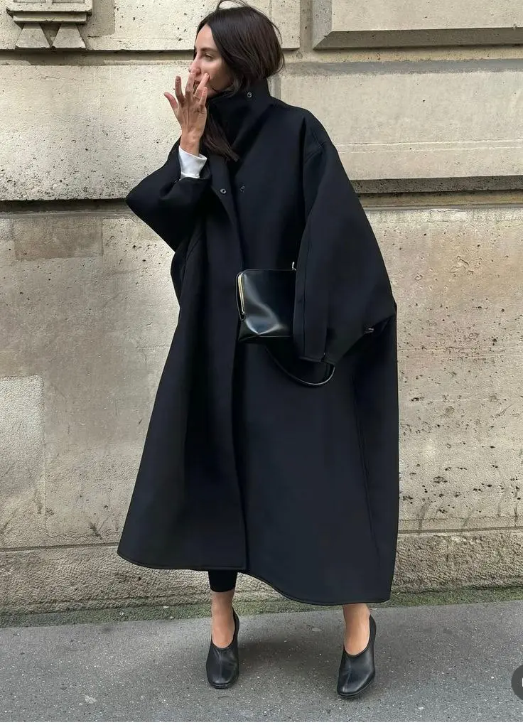 Long faux fur coat in ivory over tailored blazer and slim trousers, fashion week attendee street style autumn