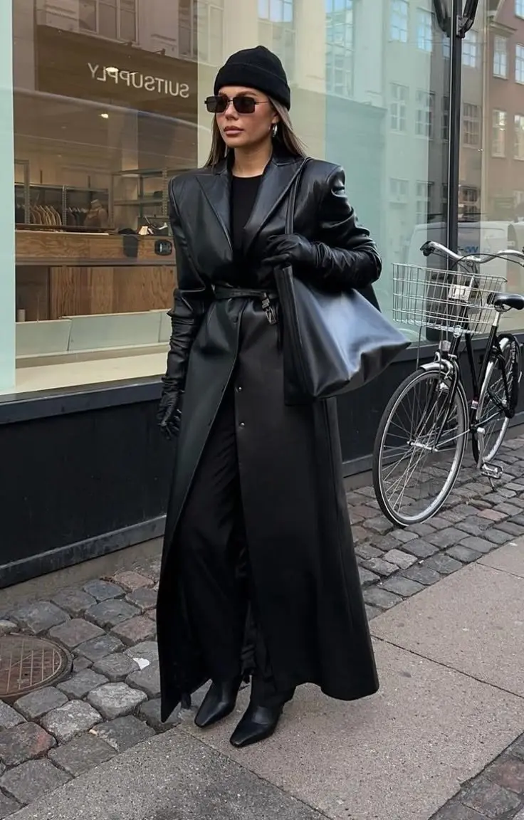 Textural layering: shearling collar coat over plaid flannel over thin knit, dark wide-leg trousers, brown boots, fall palette