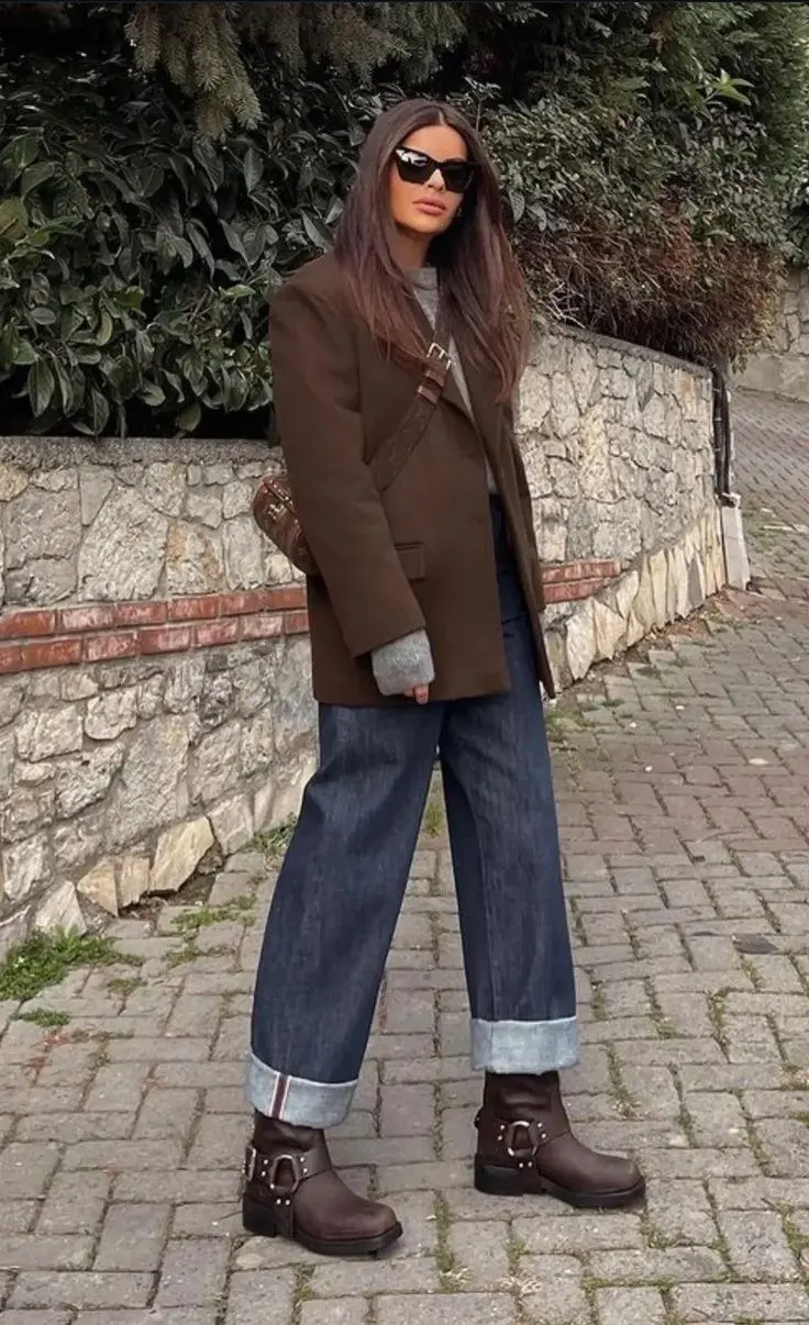 Sculptural heel ankle boots in oxblood suede, paired with straight-leg jeans and a camel coat, fall street style close-up