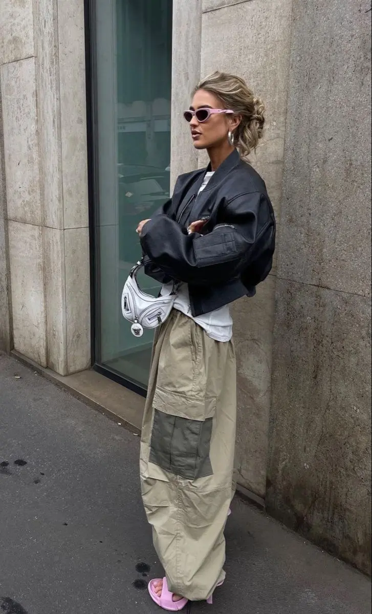 Wide-leg olive cargo pants with a cropped ribbed knit and retro runner sneakers, urban street style fall editorial