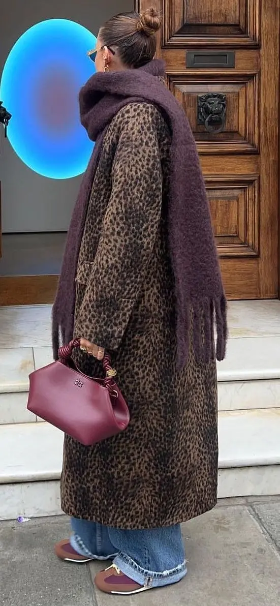 Leopard print blazer over a black tank and high-waisted black trousers, gold jewelry, fall street style editorial