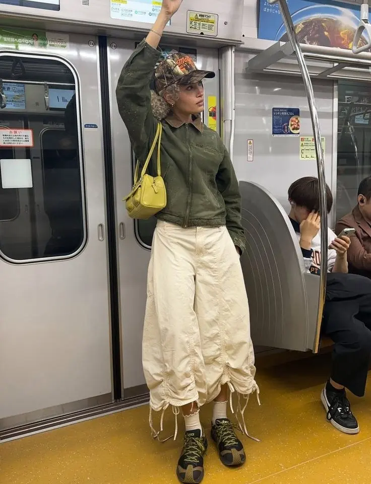 Lightweight technical anorak in slate gray worn with wide-leg cargo trousers and chunky trail sneakers, autumn editorial