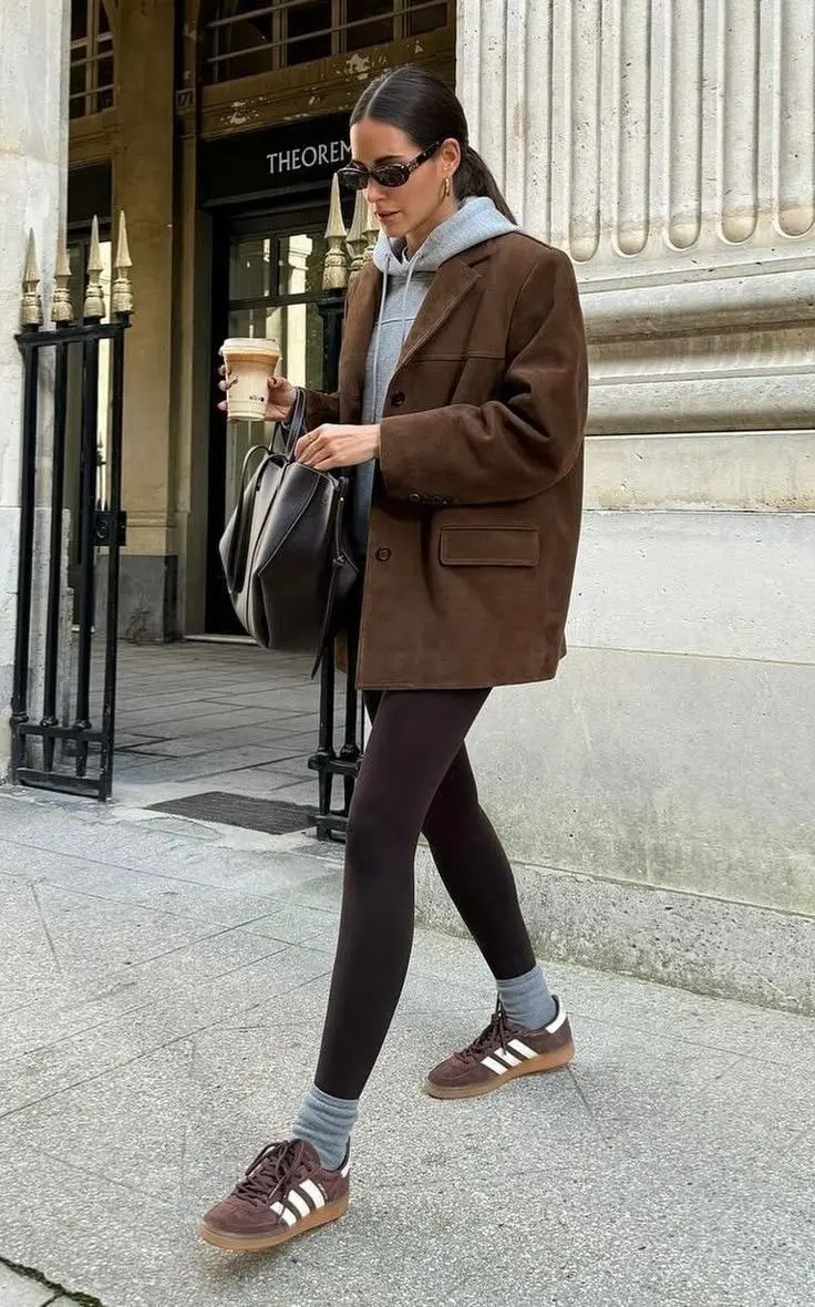 Metallic silver satin sneakers paired with straight-leg dark trousers and a structured blazer, fashion-forward fall footwear