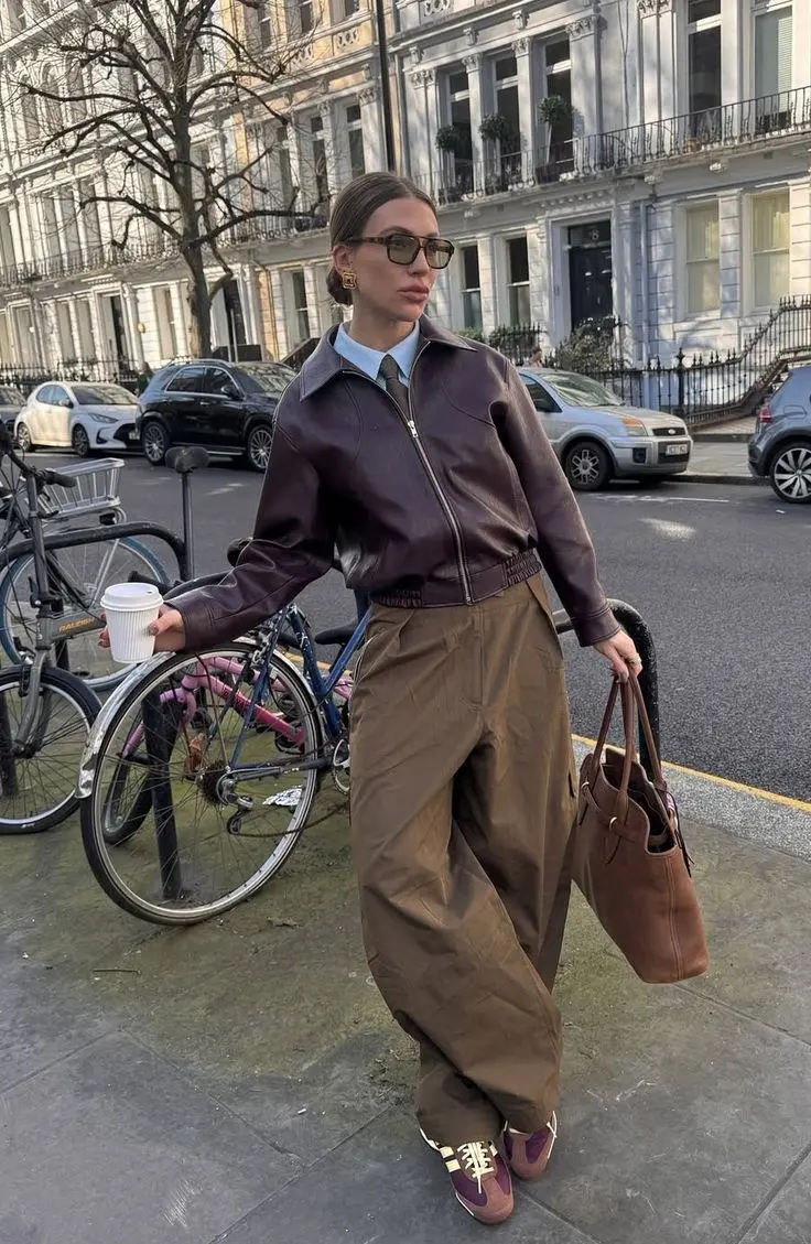Clean white leather retro runner sneaker with wide-leg camel trousers and a chunky knit, minimal fall street style