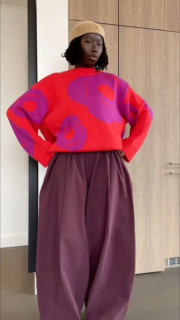 Plus size model in caramel ribbed turtleneck, faux leather midi skirt, ankle boots, editorial indoor setting