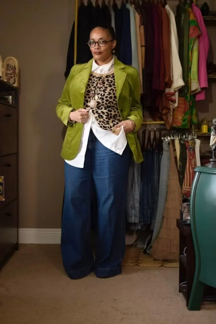Curvy fashion blogger in leopard print blazer over black fitted turtleneck, dark jeans, gold jewelry, autumn afternoon