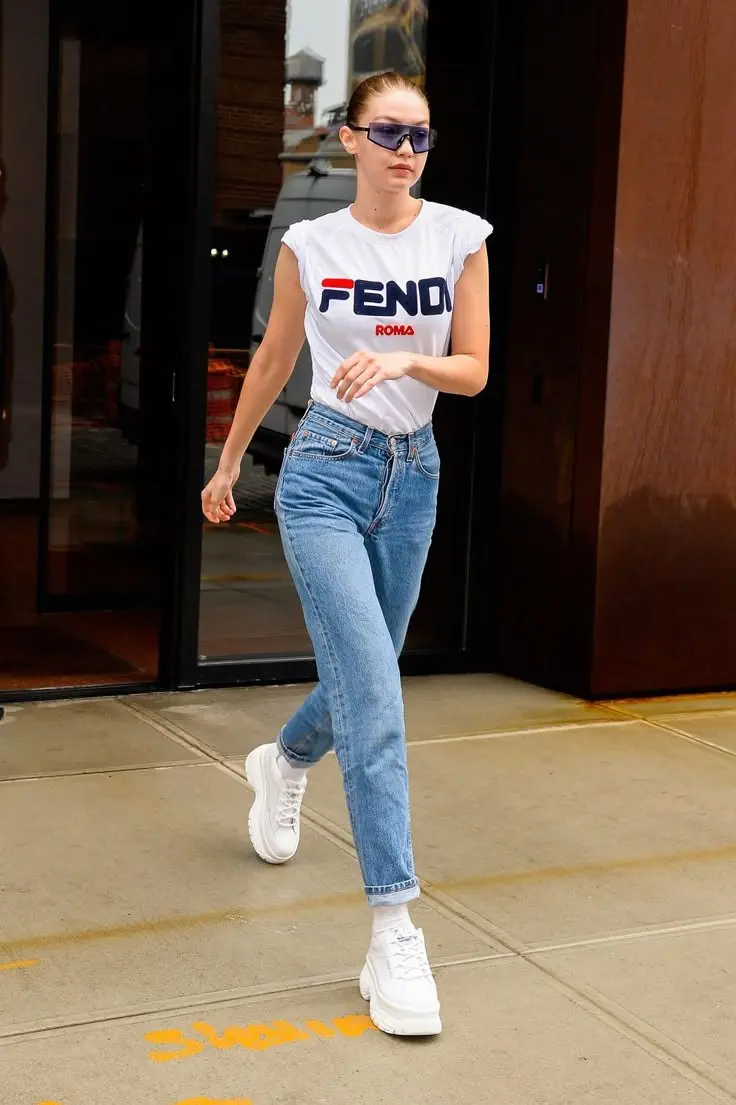 woman wearing Fendi Roma logo white graphic tee high-rise straight blue jeans white platform sneakers white socks purple rectangular sunglasses street outfit 14