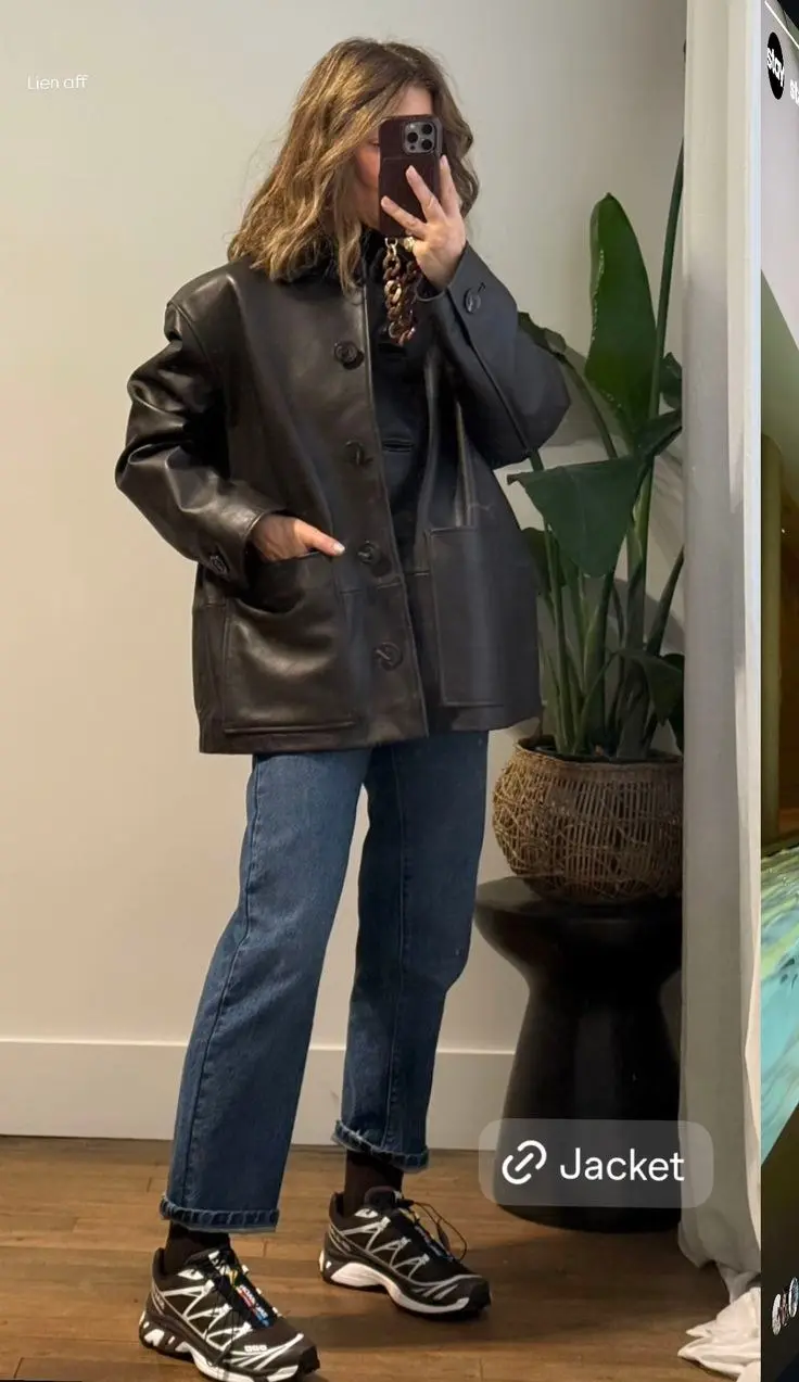 woman in dark brown leather chore coat dark base layer mid-wash straight leg raw hem jeans black salomon runners chain necklace mirror selfie outfit 20