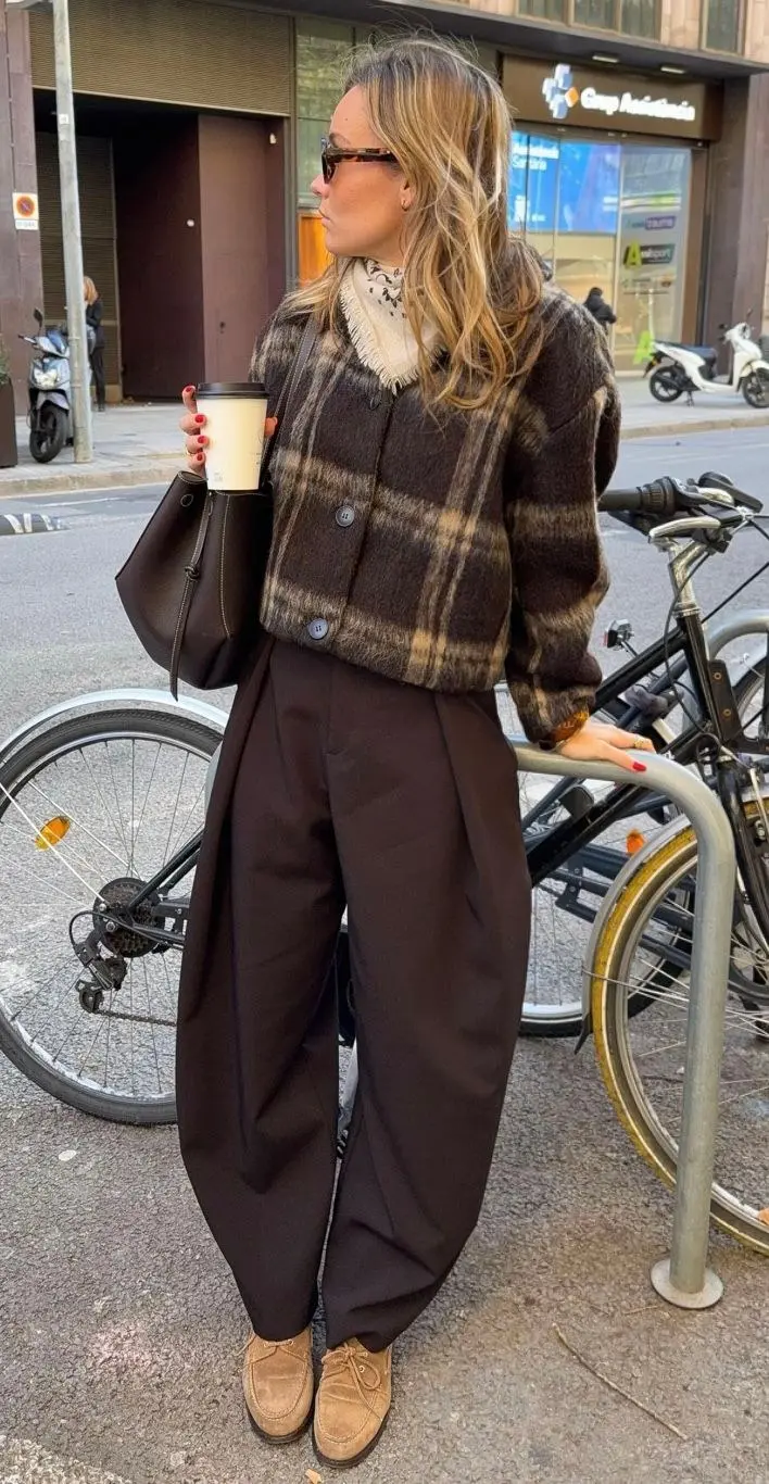 woman wearing cropped dark brown plaid jacket dark brown wide leg trousers tan suede lace up shoes dark tote bag fringed scarf tortoise sunglasses street outfit 3