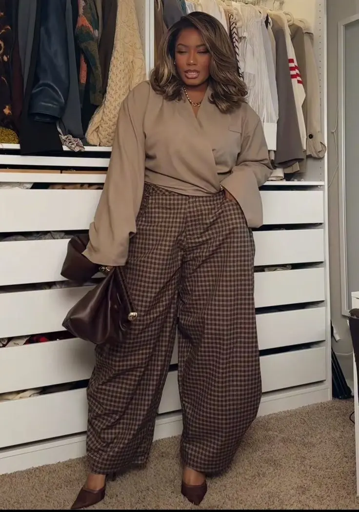 curvy woman in camel blouse brown plaid wide leg trousers dark brown pointed mules chocolate leather bag closet background outfit 2