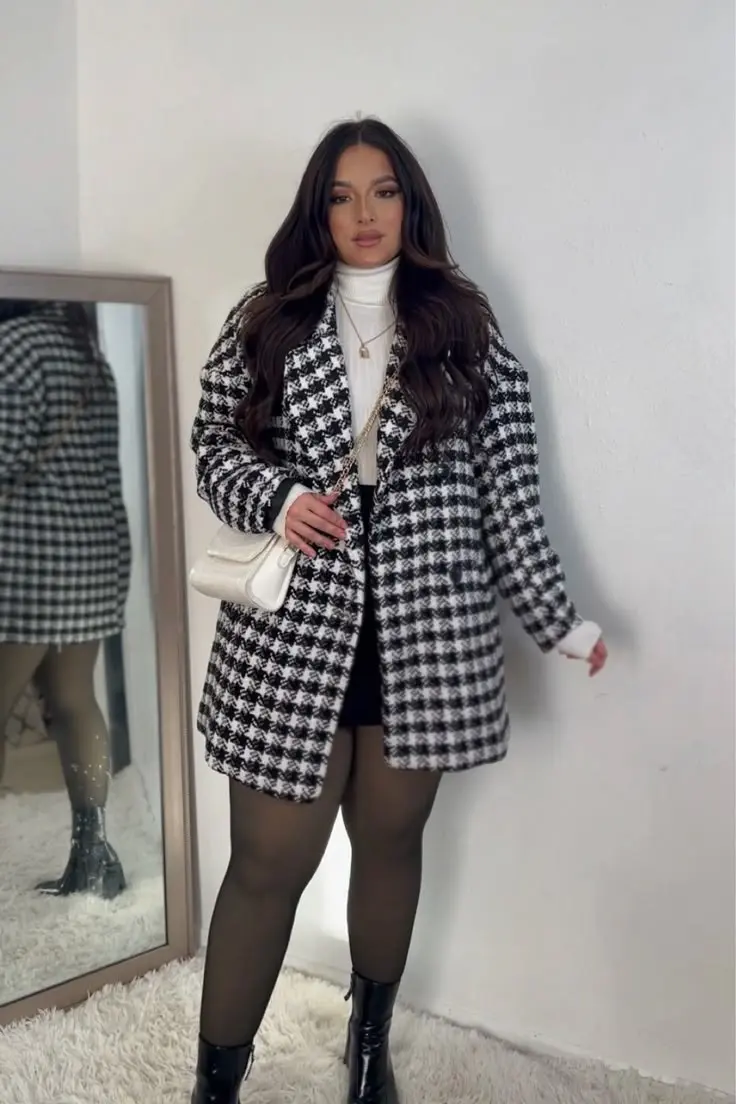 curvy woman in large houndstooth coat white turtleneck black mini skirt dark tights black ankle boots white quilted chain bag outfit 6