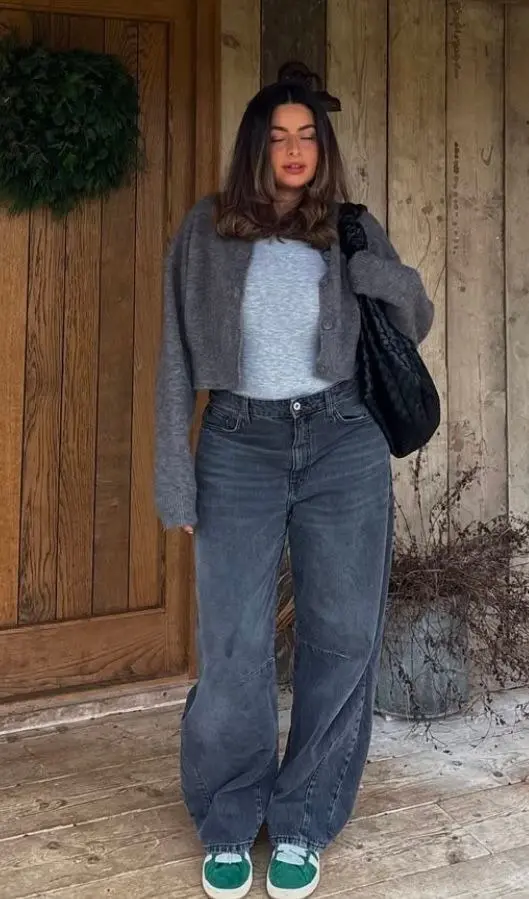 woman in grey cropped button cardigan grey fitted tee charcoal wide leg jeans green sneakers black quilted shoulder bag outdoor outfit 6