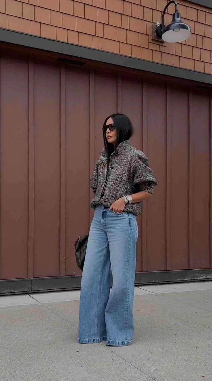 woman in brown tweed boxy jacket light blue wide leg jeans silver watch sunglasses brown monogram bag street outfit 11