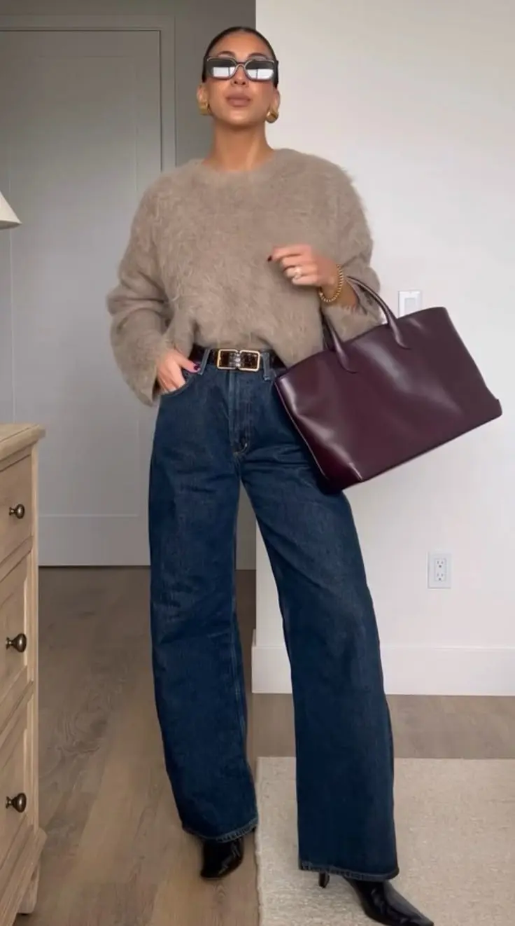 woman in taupe fuzzy knit sweater wide croc belt dark navy wide leg jeans black kitten heel boots burgundy structured tote bag large sunglasses indoor outfit 14