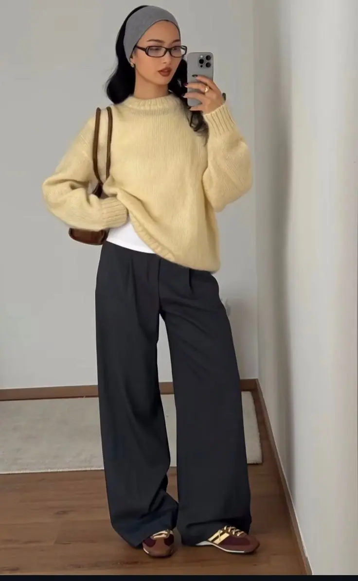 woman in cream chunky knit sweater white undershirt grey charcoal wide leg trousers retro sneakers brown shoulder bag grey headband glasses mirror selfie outfit 22