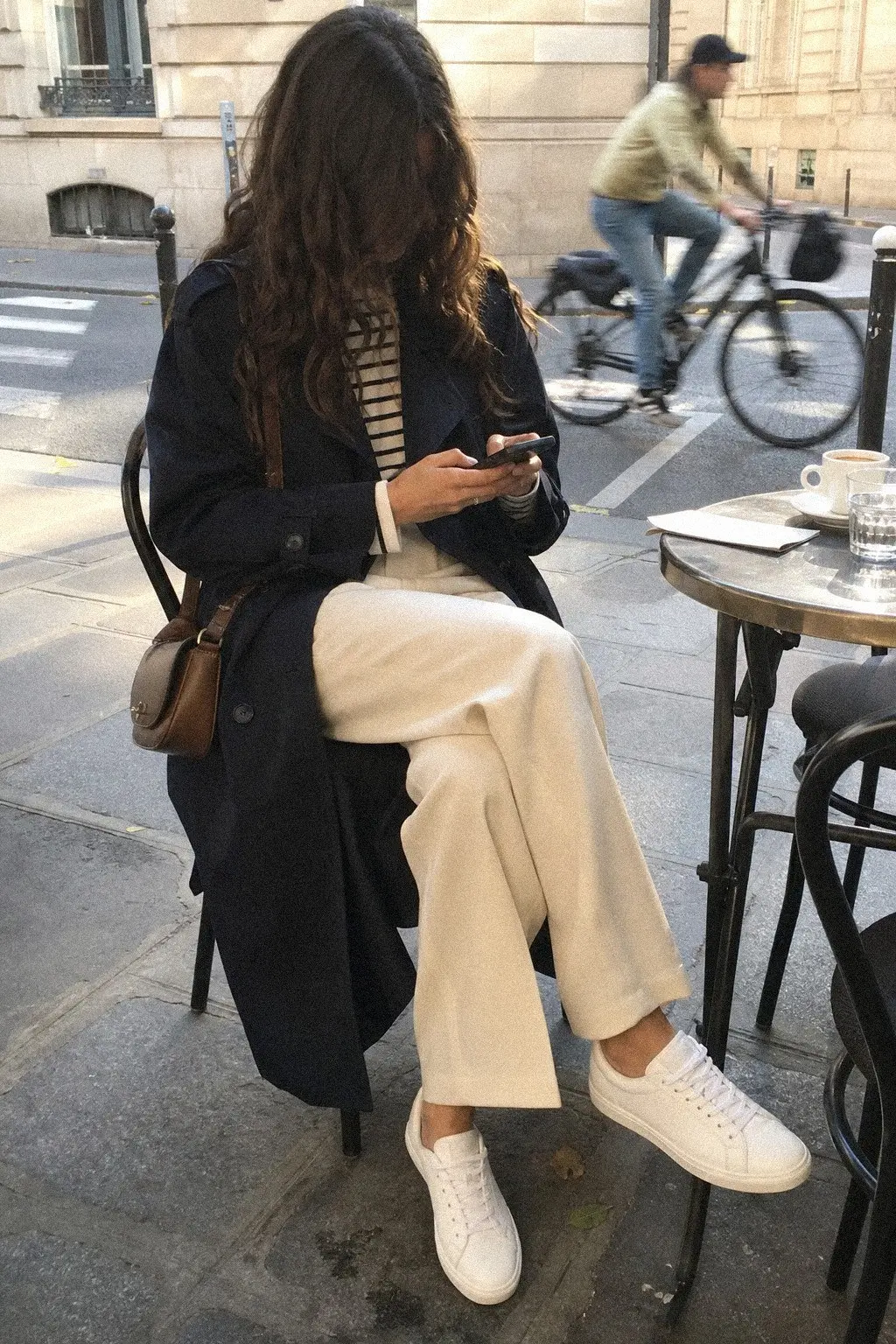 navy trench coat breton stripe top cream straight trousers white sneakers fall work outfit photo 5