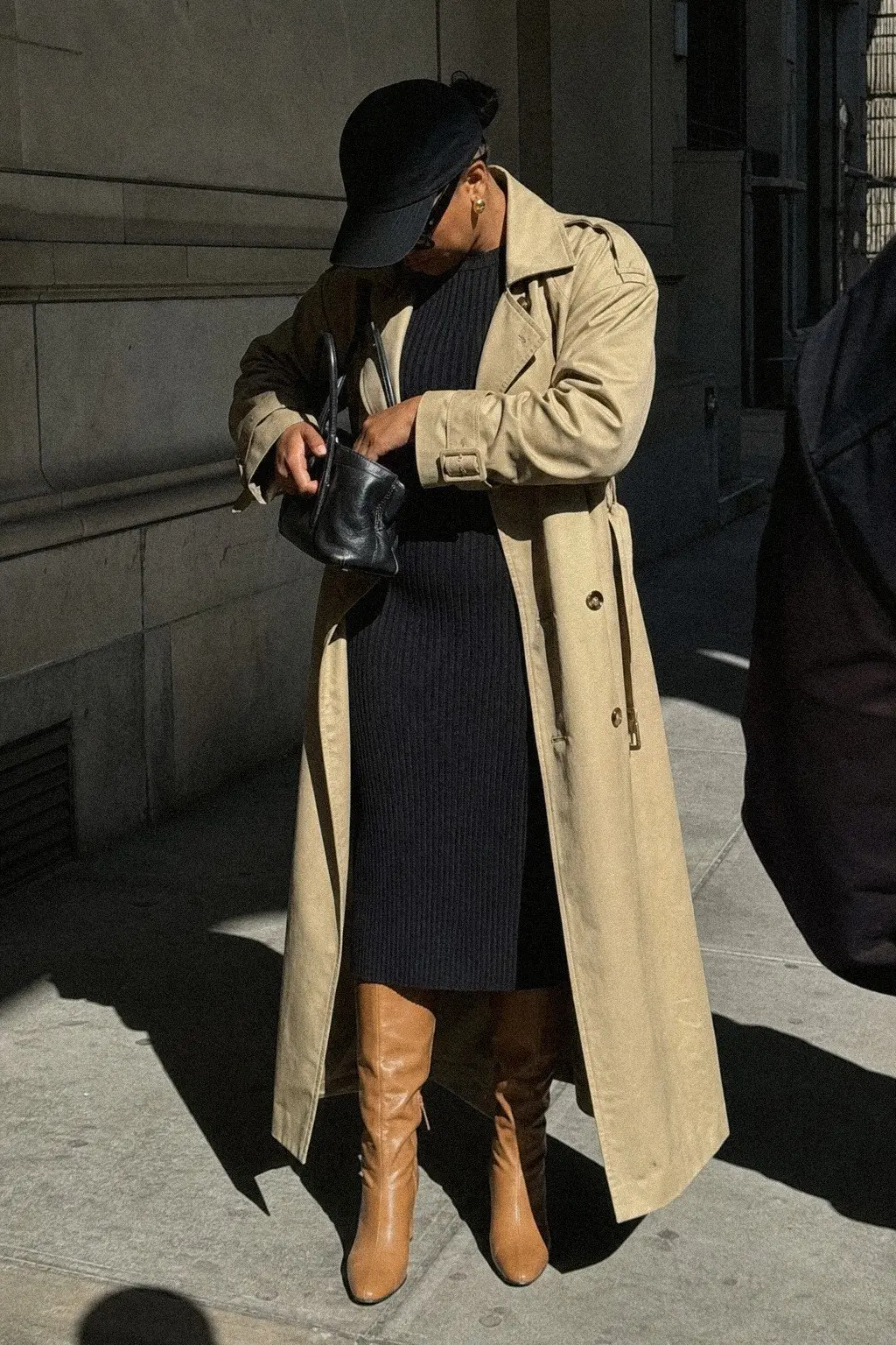 stone trench coat black ribbed knit midi dress tan knee-high boots fall work outfit photo 8