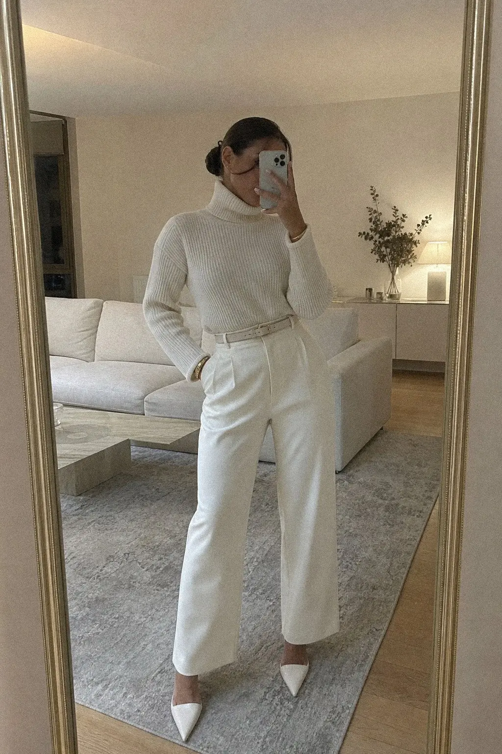 ivory ribbed turtleneck tucked into wide-leg cream trousers with pointed mules white christmas outfit 1